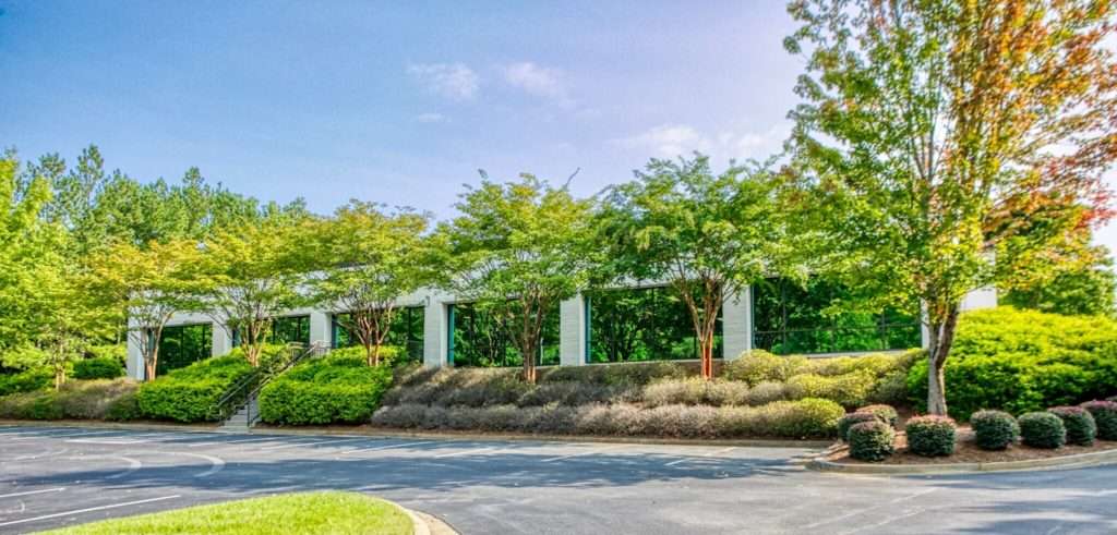 Exterior view of 157 Technology Parkway, Peachtree Corners, GA, leased by Elevation Autism with representation from Stratus Property Group.