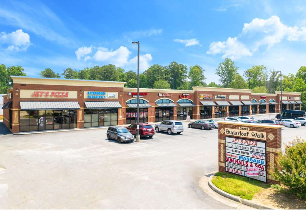 Exterior view of Sugarloaf Walk retail property at 2695 Sugarloaf Parkway, Lawrenceville, GA, sold by Stratus Property Group.